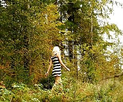 Young blonde with a lot of tattoos pisses in woods