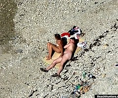 Overheated beach nudists sunbathing and feeling up